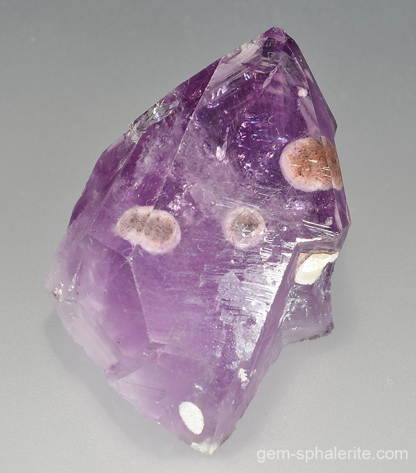 Fine polished specimen of light amethyst with cristobalite and goethite inclusions